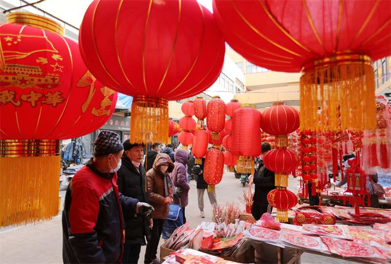 圖為市民在日照太陽(yáng)城市場(chǎng)內(nèi)選購(gòu)各類新年飾品。于坤帥攝
