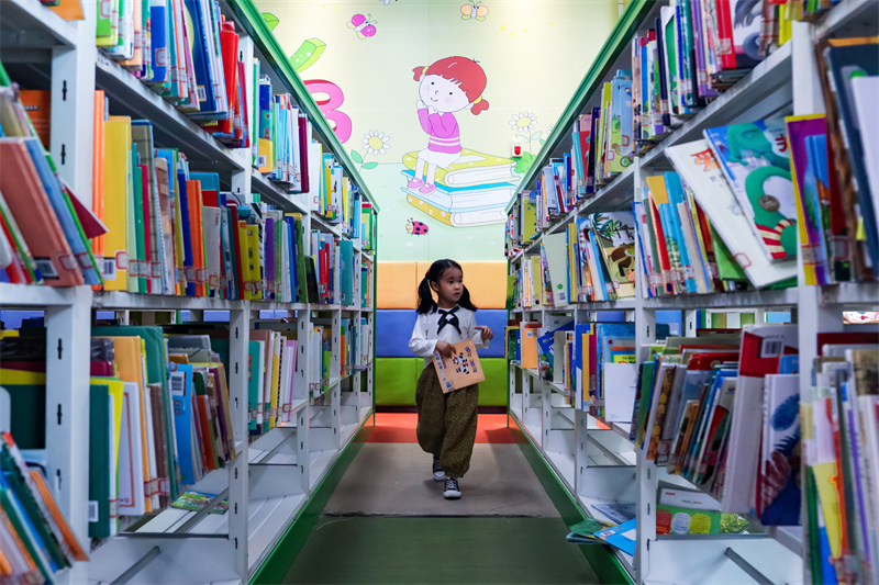 在山東省日照市圖書館內(nèi)，一名小朋友正在挑選自己喜歡的書籍。張明慷攝